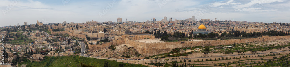 Beautiful panoramic aerial view of the Old City, Tomb of the Prophets and Dome of the Rock during a sunny and cloudy day. Taken in Jerusalem, Capital of Israel.