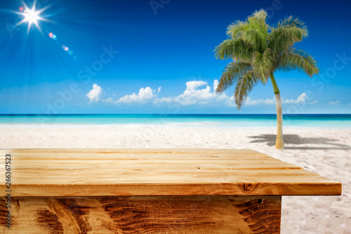 Fototapeta Naklejka Na Ścianę i Meble -  Desk of free space and summer background of ocean and beach with palm. Sunny day and blue sky. 