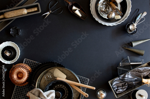 Baking and patisserie equipment over black background with copy space