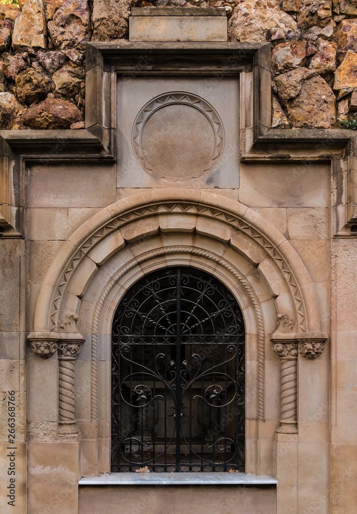 The door of the stone crypt on the Montjuic Cemetery closeup front view, Barcelona, Catalonia, Spain The door of the stone crypt on the Montjuic Cemetery closeup front view, Barcelona, Catalonia, Spain