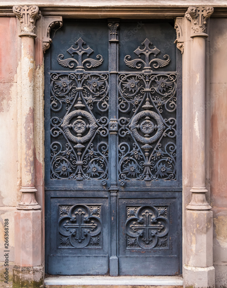 The wrought door of the stone crypt on the Montjuic Cemetery closeup front view, Barcelona, Catalonia, Spain