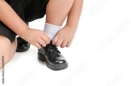Thai student boy is tying the laces student shoe isolated