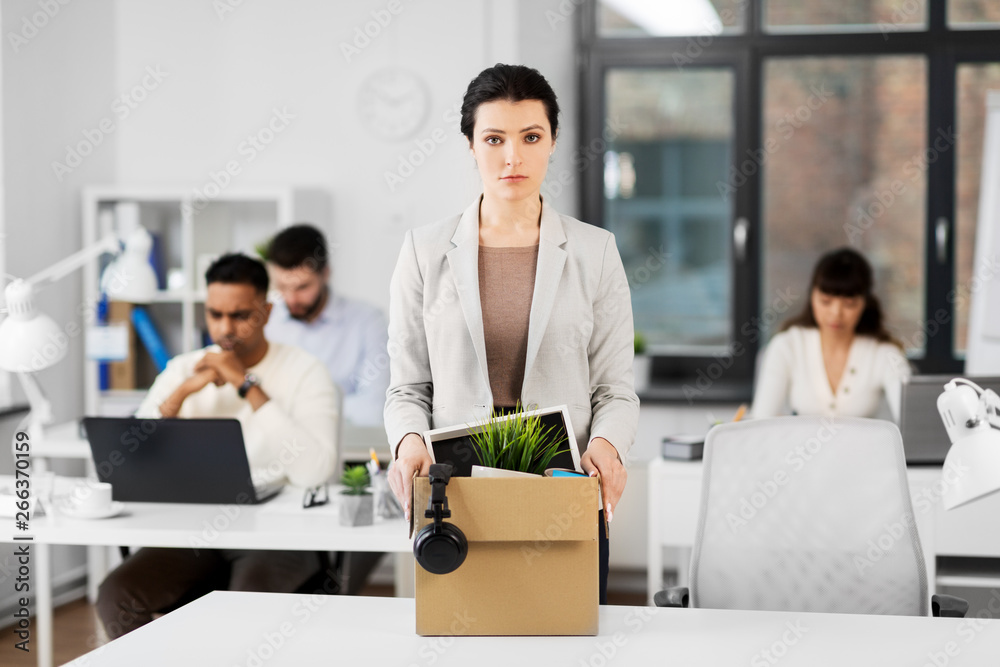 business, firing and job loss concept - sad fired female office worker with box of her personal stuff business, firing and job loss concept - sad fired female office worker with box of her personal stuff