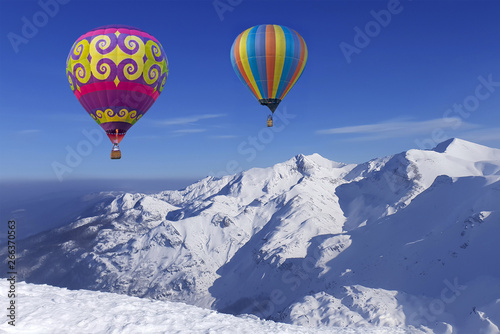 Colorful balloons flying over snow-covered mountains