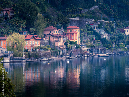Image of beautiful houses along the lake maggiore in italy with water reflections