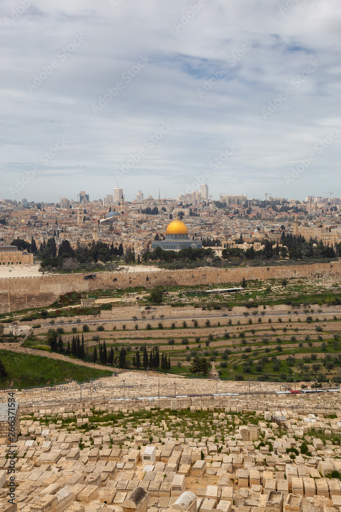 Beautiful aerial view of the Old City, Tomb of the Prophets and Dome of the Rock during a sunny and cloudy day. Taken in Jerusalem, Capital of Israel.