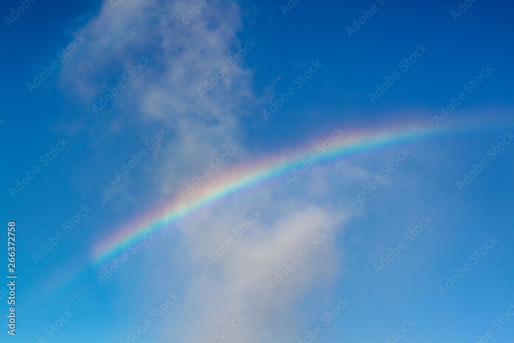 Gorgeous view of rainbow on blue sky. Beautiful nature backgrounds. Gorgeous view of rainbow on blue sky. Beautiful nature backgrounds.