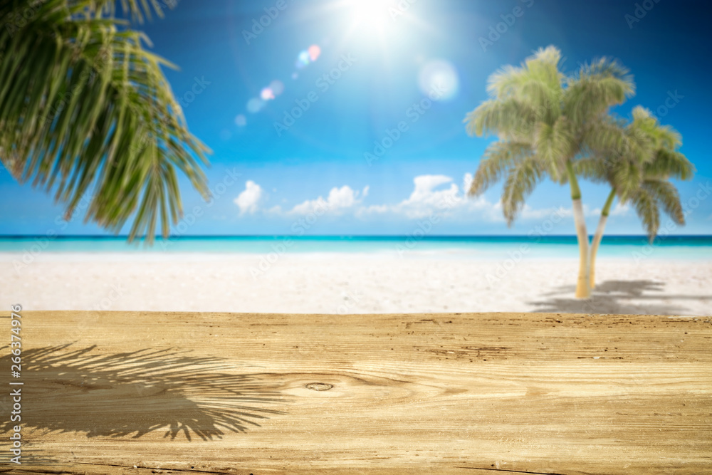 Fototapeta premium Desk of free space and summer landscape with palms and ocean