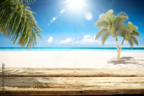 Desk of free space and summer landscape with palms and ocean 