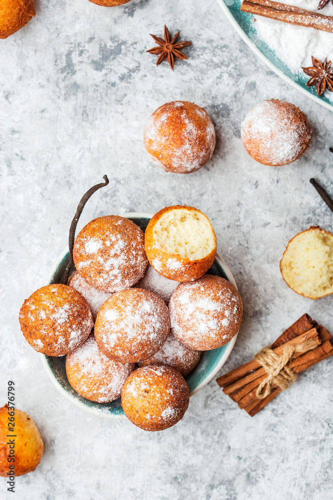 Fototapeta premium small balls cottage cheese doughnuts in powdered sugar