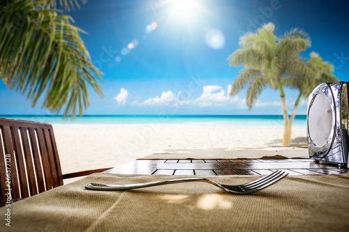 Desk of free space and summer landscape with palms and ocean 