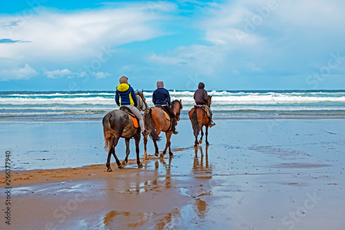 Horse riding at Carapateira beach in the Algarve Portugal © Nataraj