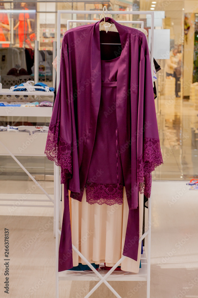 Female red satin nightgown at the store. Advertise, Sale, Fashion concept. Female red satin nightgown at the store. Advertise, Sale, Fashion concept.