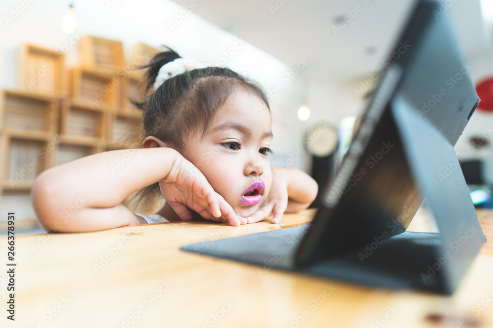 Asian little girl Sitting Tablet at home Asian little girl Sitting Tablet at home