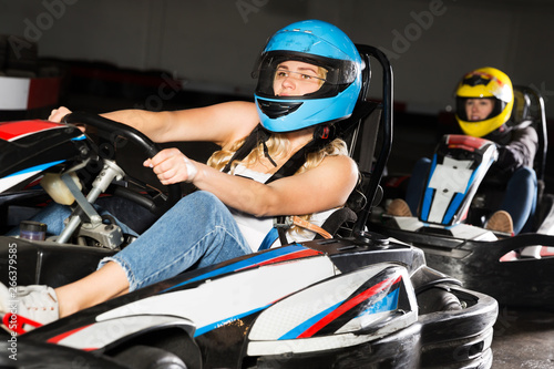 Female driving go-kart car indoor