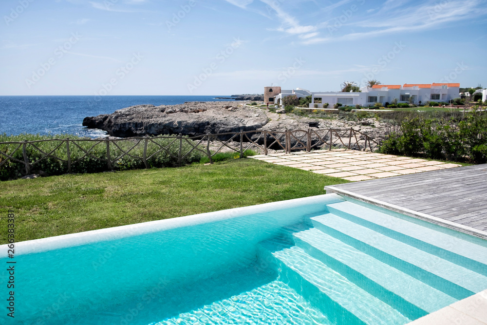 Fototapeta premium Swimming pool stairs next to the sea