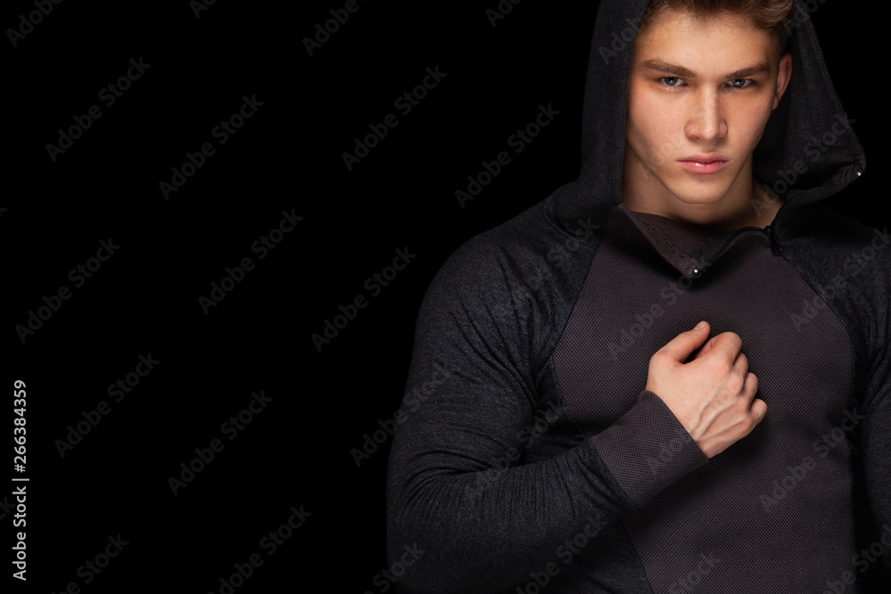 Men fashion. Close-up portrait of a brutal and fit man. Athlete bodybuilder on black background.