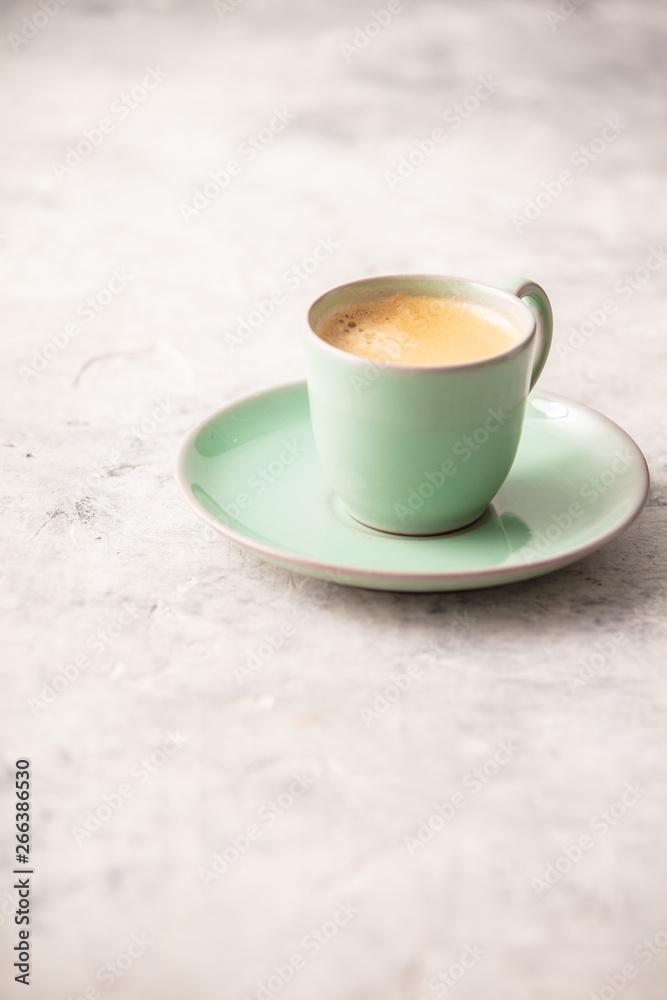 A cup of coffee on light grey background A cup of coffee on light grey background