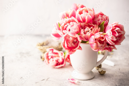 Spring flowers and Easter decorations on shabby chic background photo