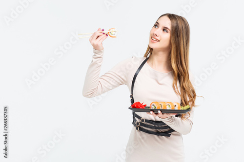 Gorgeous long haired model eating chinese food against white background in a studio environmen. Copy space!