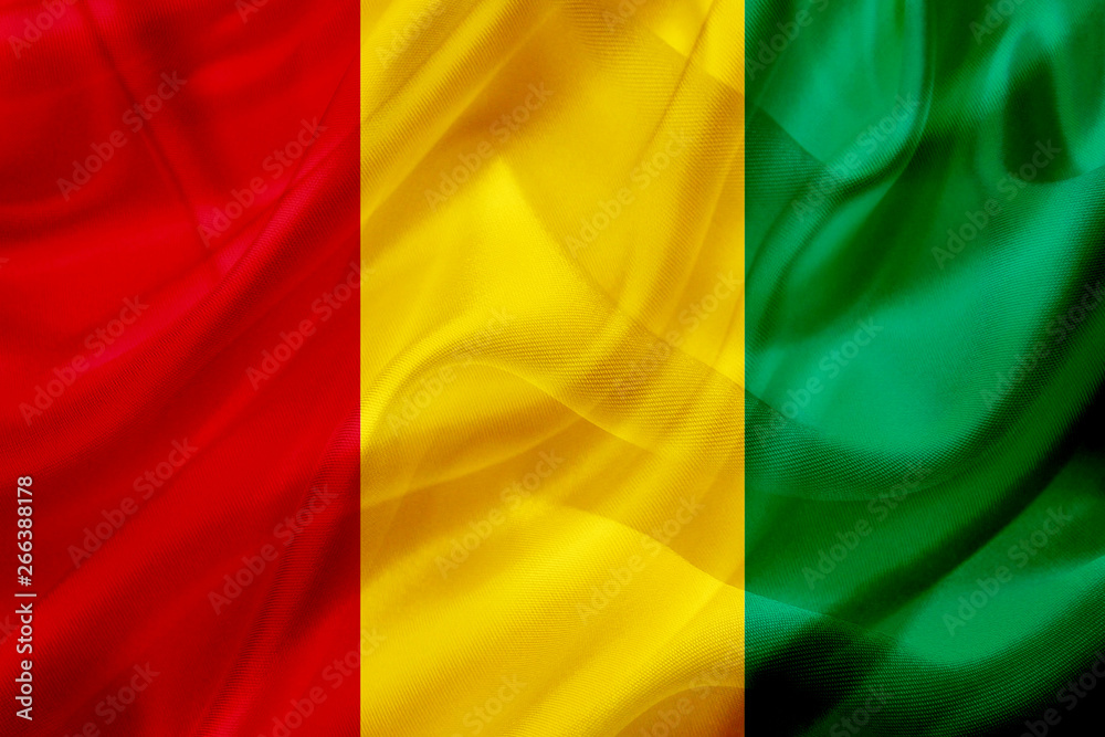 Guinea country flag on silk or silky waving texture Guinea country flag on silk or silky waving texture