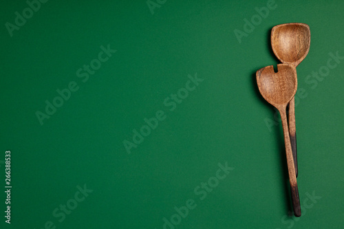 Wooden serving spoons on colorful background