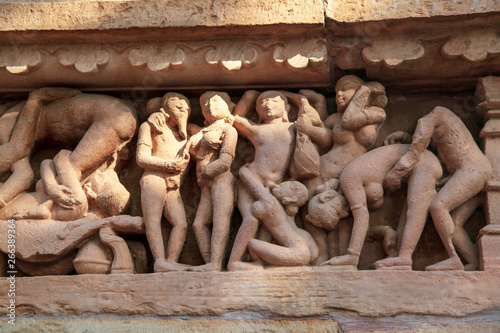 Sculptures depicting people having sex on the walls of ancient temples of Kama Sutra in India kajuraho. UNESCO world heritage site. The most famous landmark in India. Temple of love photo