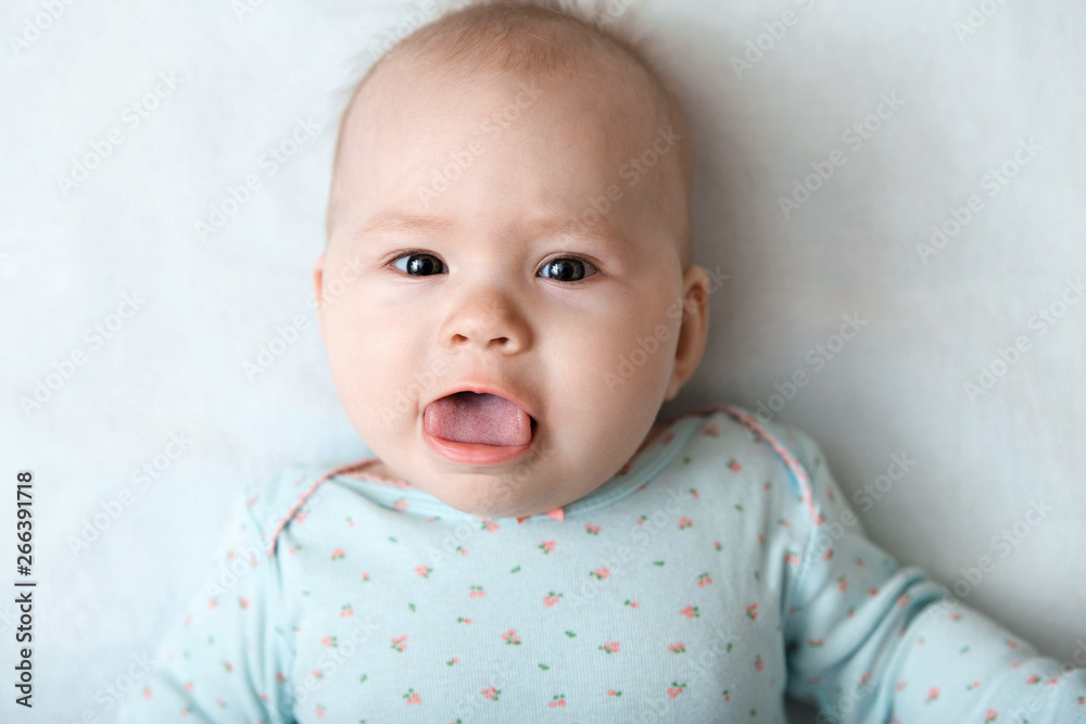 Portrait of a smiling baby in bed. Baby smiling and looking up to camera. Good morning! Portrait of a smiling baby in bed. Baby smiling and looking up to camera. Good morning!