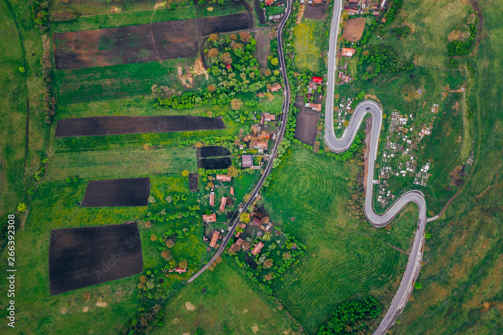 Obraz premium Curvy road from a drone view and agriculture fields