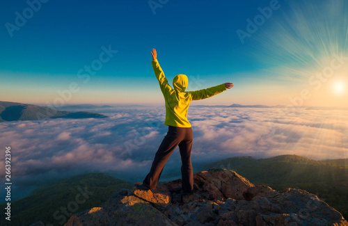 Fotografie A woman on top mountain, summer cloudscape