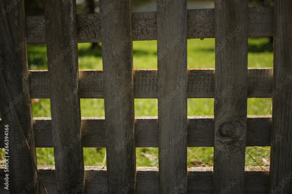 Wooden fence, rhombuses and squares. Texture of white old boards.