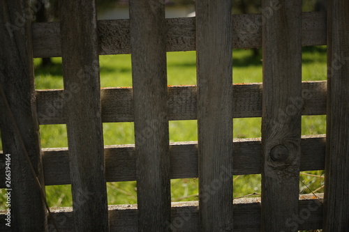 Wooden fence, rhombuses and squares. Texture of white old boards.