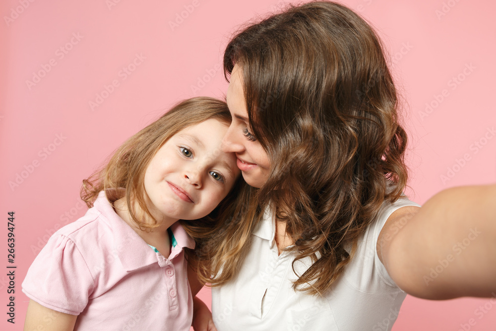 Close up selfie shot woman in light clothes have fun with cute child baby girl. Mother, little kid daughter isolated on pastel pink wall background, studio portrait. Mother's Day, love family concept. Close up selfie shot woman in light clothes have fun with cute child baby girl. Mother, little kid daughter isolated on pastel pink wall background, studio portrait. Mother's Day, love family concept.