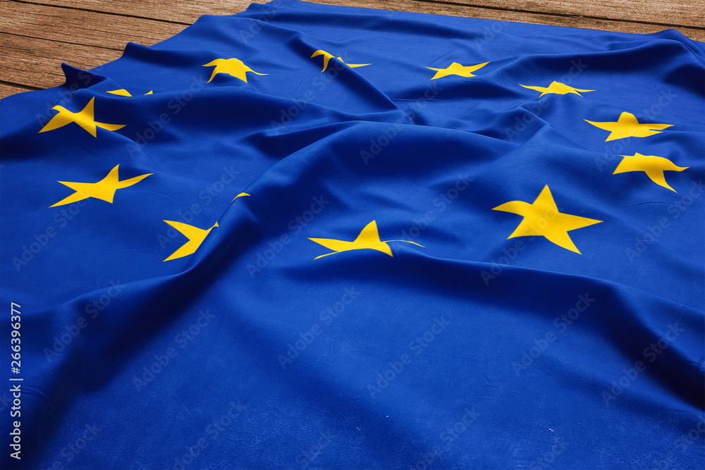 Flag of European Union on a wooden desk background. Silk EU flag top view. Flag of European Union on a wooden desk background. Silk EU flag top view.