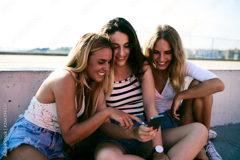 Friends using mobile phone