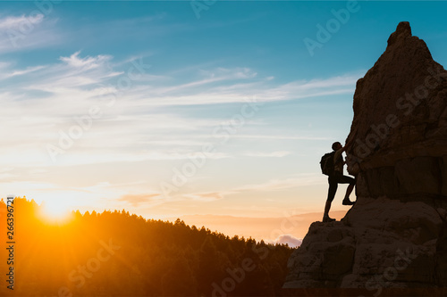 silhouette of successful climbing woman in mountains Concept of concept of motion motivation inspiration at beautiful sunset photo