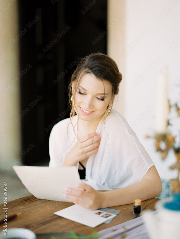 Smiling woman reading letter