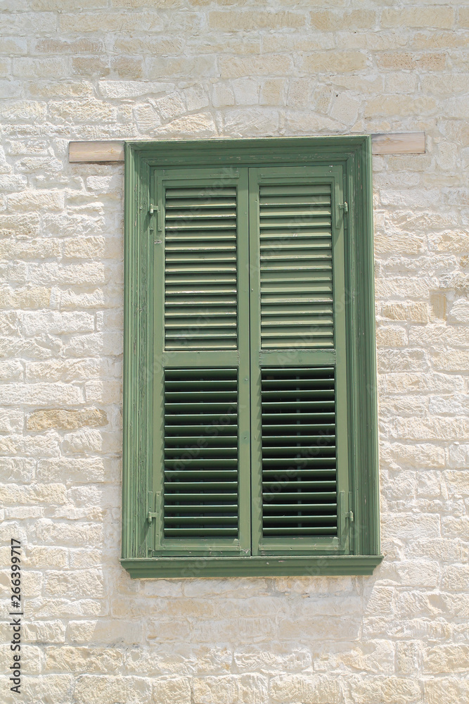 Window with wooden shutters in stone wall Window with wooden shutters in stone wall