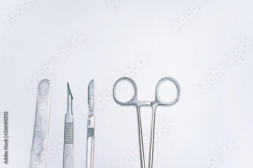 Canvastavla Scapula for throat, two scalpels and clamp on a light background
