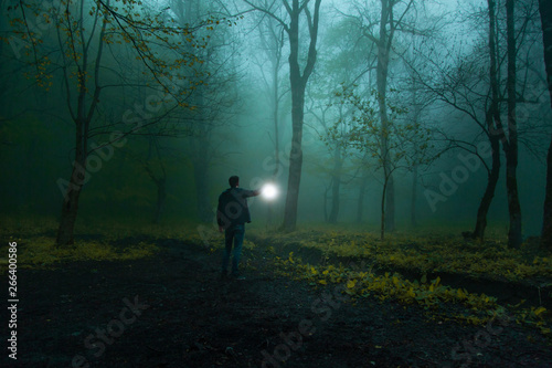 man hand lamp in night forest © ARAMYAN