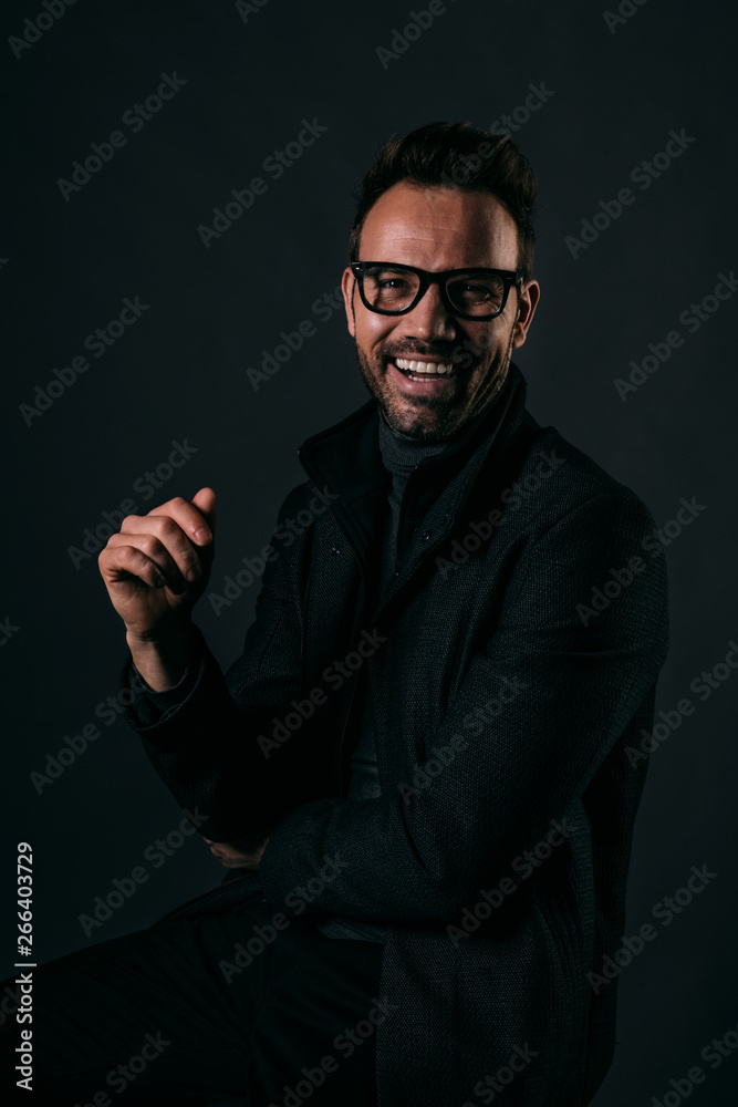 Portrait of happy handsome man over dark background Portrait of happy handsome man over dark background