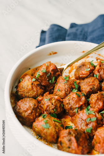 Closeup of marinara meatballs in a serving platter photo