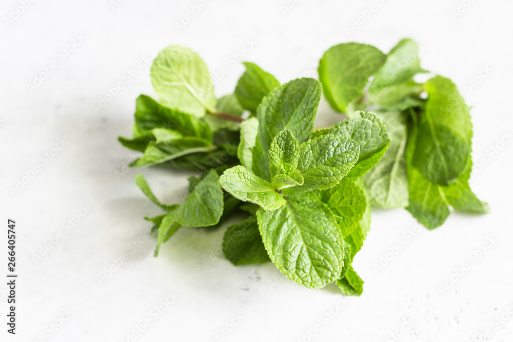 Fresh mint leaves on grey stone table. Copy space. Fresh mint leaves on grey stone table. Copy space.