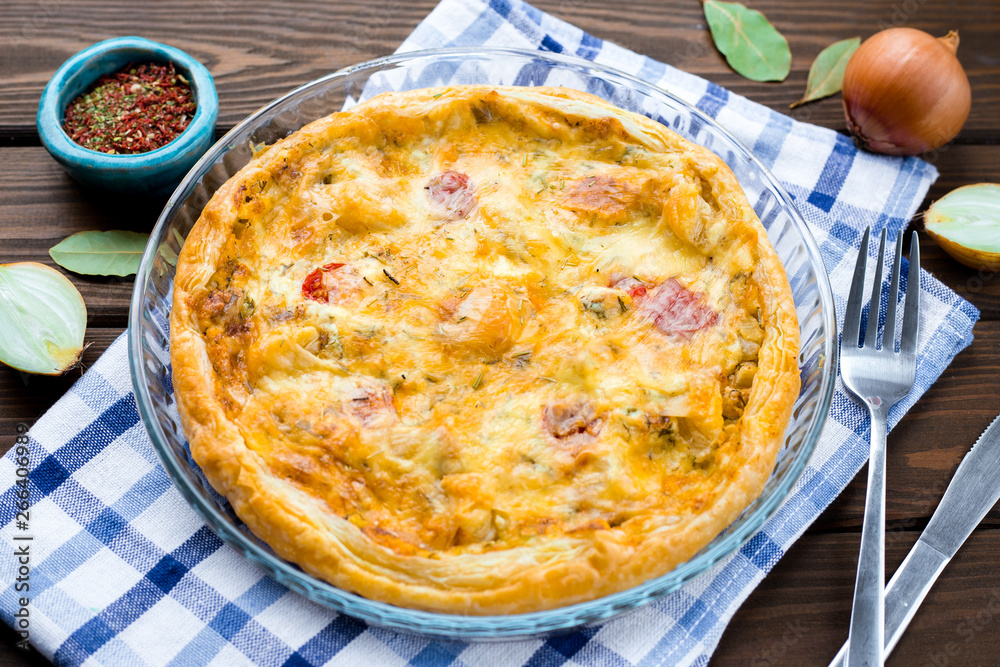Rustic large tart with cloth on a wooden table, view from above, close-up
