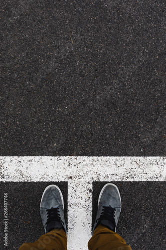 Point of view to a Street marking on black asphalt