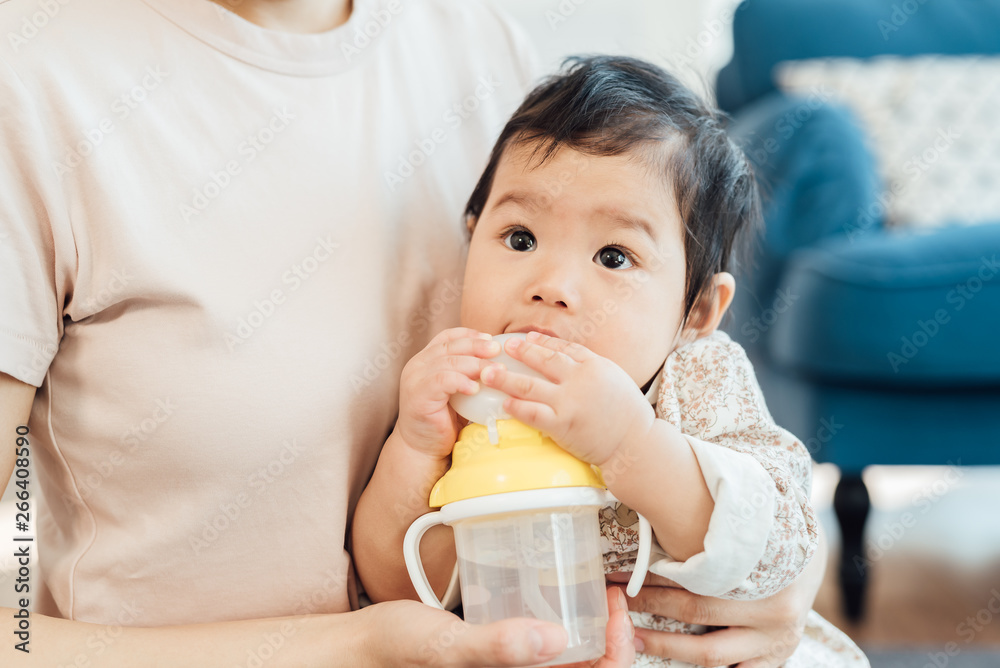 Adorable girl drinking water with her mother Adorable girl drinking water with her mother