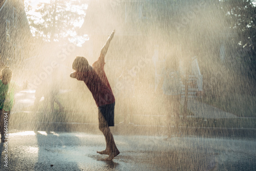 Kid having fun in rain photo
