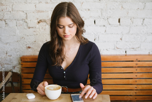 Young woman listening to music on bluetooth headset photo