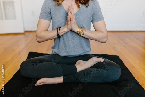 Beautiful woman practicing meditation at home photo