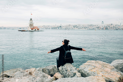 Woman enjoying the view in front of the Maiden?s Tower in Istanbul photo